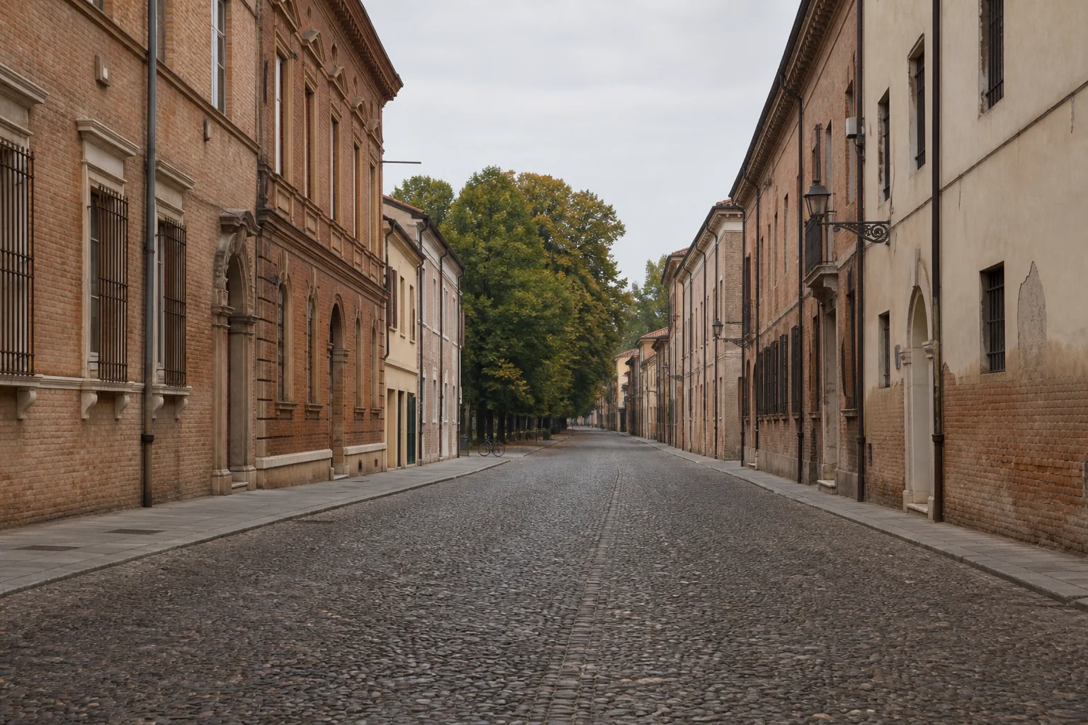 The long cobbled perspective of Corso Ercole I d’Este between red-brick Renaissance palazzi in Ferrara